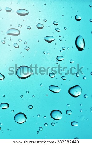 Waterdrops on a blue window 