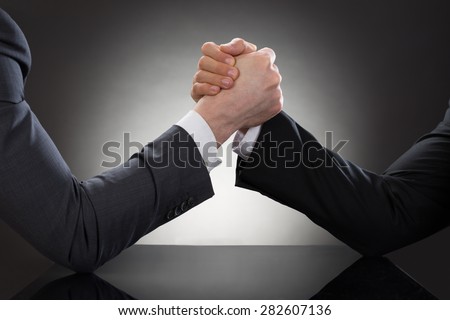 Close-up Of A Two Businessman Competing In Arm Wrestling