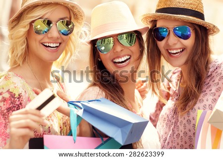 A picture of a group of happy friends shopping in the city