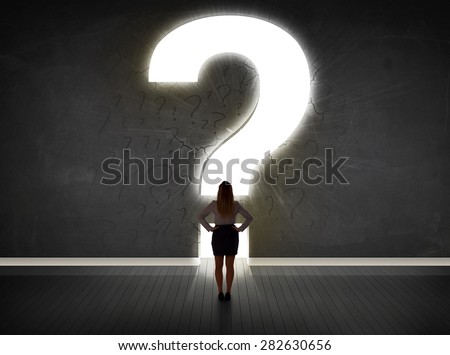 Business woman looking at wall with a bright question mark concept
