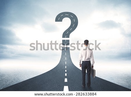 Business person lokking at road with question mark sign concept