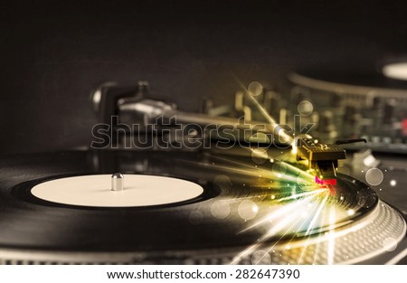 Music player playing vinyl with glow lines comming from the needle concept on background
