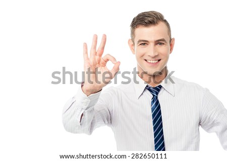 Smiling businessmen showing ok sign