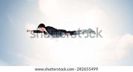 Business man flying like a superhero in clouds on the sky concept