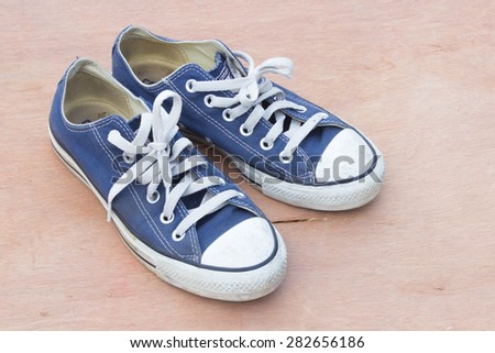 canvas  blue shoes on the wood background
