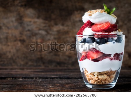 Sweet dessert in glass with biscuit,berry fruit and whipped cream,selective focus and blank space Royalty-Free Stock Photo #282665780