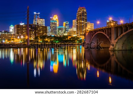 The Central Avenue Bridge and skyline reflecting in the Mississippi River at night, in Minneapolis, Minnesota.