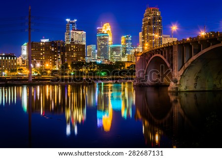 The Central Avenue Bridge and skyline reflecting in the Mississippi River at night, in Minneapolis, Minnesota.