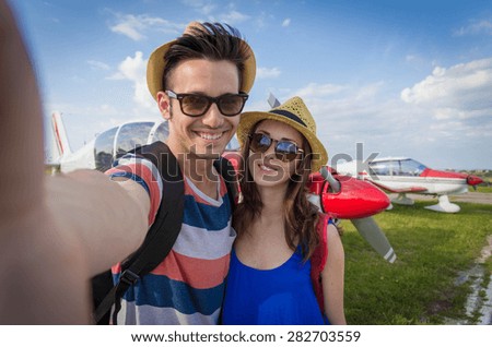 Couple in love take a selfie in front of the planes