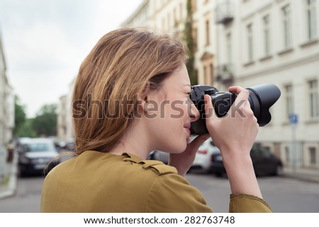 Close up Blond Teen Girl Photographer at the Street, Shooting Outdoor Scenes Using DSLR Photo Camera.