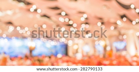 blur image of party hall stage set for background usage .