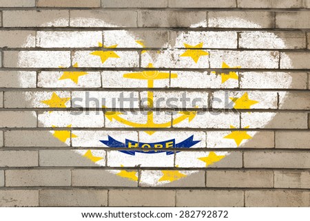 heart shaped flag in colors of rhode island on brick wall