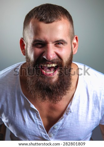Portrait of handsome bearded man isolated on grey background.