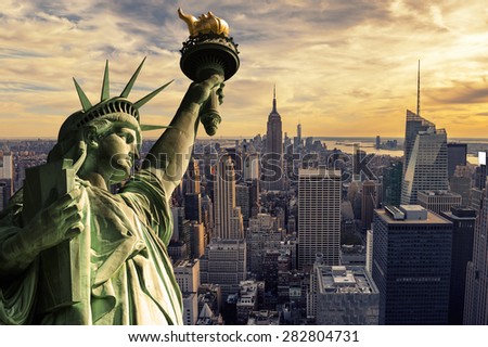 The Statue of Liberty and New York City skyline at dark