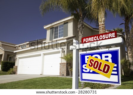 Blue Foreclosure For Sale Real Estate Sign in Front of House.