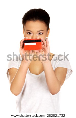 African woman holding a credit card.