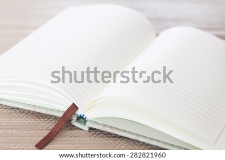 Open blank notebook on table, stock photo