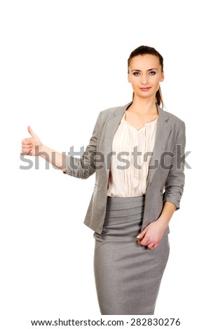 Happy smiling businesswoman with thumbs up gesture.