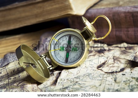 Compass on old books background