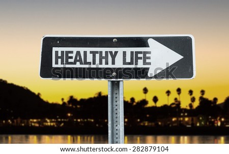 Healthy Life direction sign with sunset background