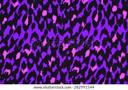 Purple and pink leopard fur pattern. Colorful spotted animal print as background.