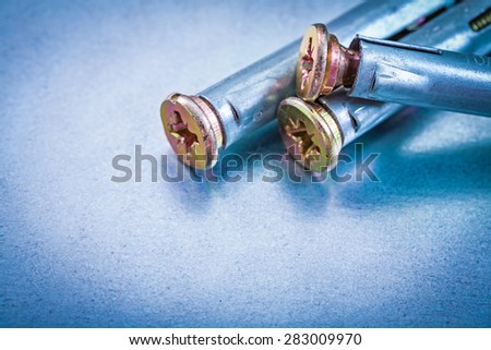 Metal anchor bolts for concrete walls on metallic background construction concept 