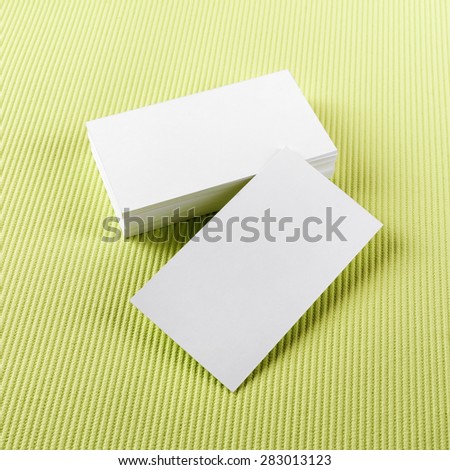 Photo of blank business cards on green background. Template for branding identity.