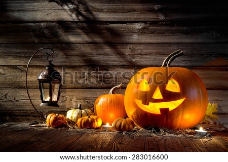 Halloween pumpkin head jack lantern on wooden background Royalty-Free Stock Photo #283016600
