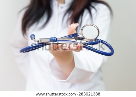 Hand holding stethoscope 