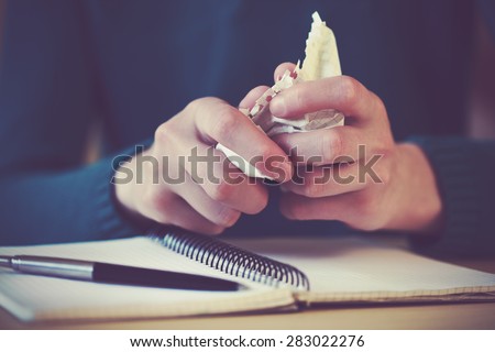 hands wresting the sheet of paper and making paper ball after mistake during writing Royalty-Free Stock Photo #283022276
