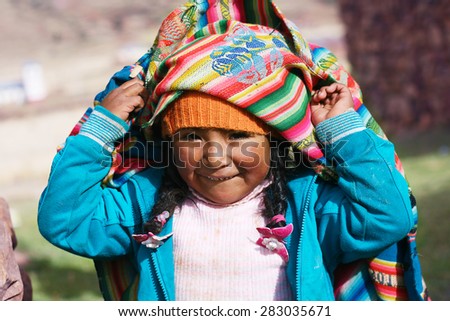 aymara girl playing with traditional cloth Royalty-Free Stock Photo #283035671