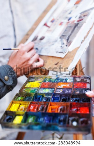 Artist hand and color palette