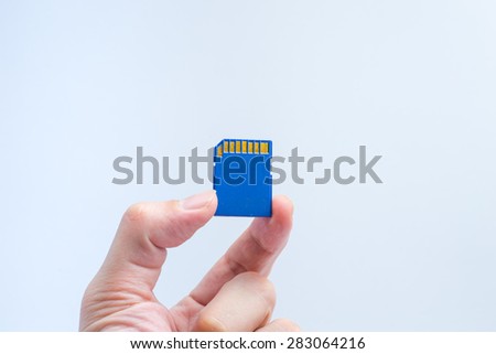 SD memory card with hand and finger hold isolate on white background.