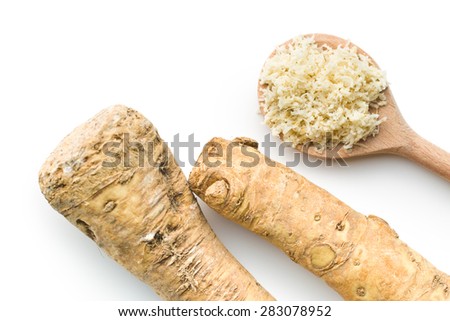 grated horseradish root on white background
