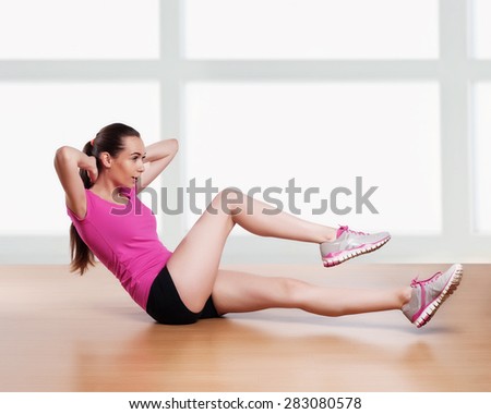 one woman exercising crunches fitness workout arms behind head 