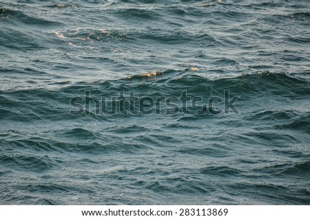 Blue Still Sea Water With Ripple. Natural Background Photo Texture