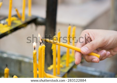 Hand of Asian women Candles  for worship to Buddha