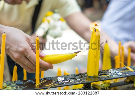 Hand of Asian women Candles  for worship to Buddha