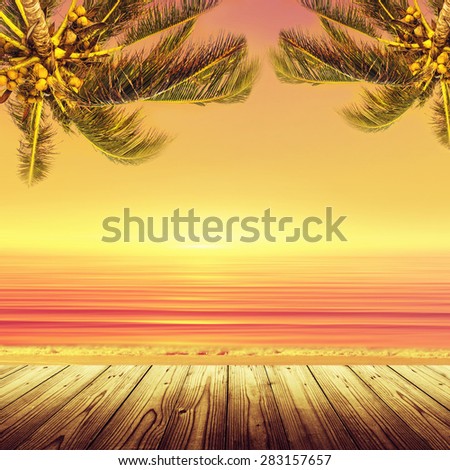 Coconut palm tree and sunset ocean landscape. Tropical paradise. Empty wooden table.