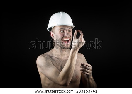 Happy dirty worker in helmet. gemstone, 