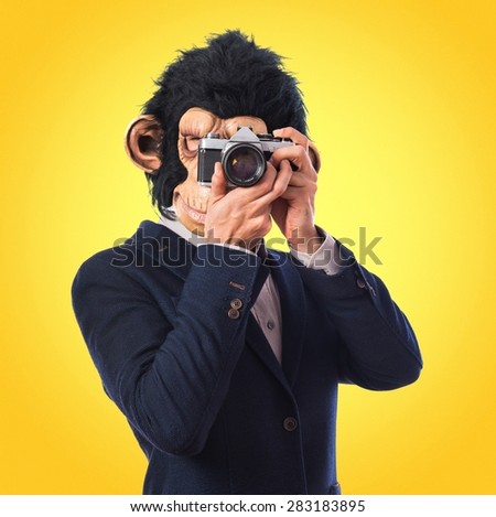 Monkey man photographing over colorful background