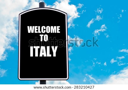 Black road sign with greeting message WELCOME TO ITALY isolated over clear blue sky background with available copy space. Travel destination concept  image