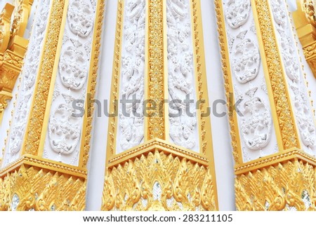 Thailand architectural designs on the walls around the  white and gold temple