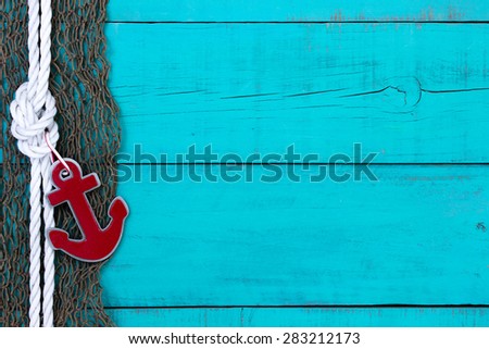 Blank rustic teal blue wooden nautical sign with fish net, red anchor and white rope border