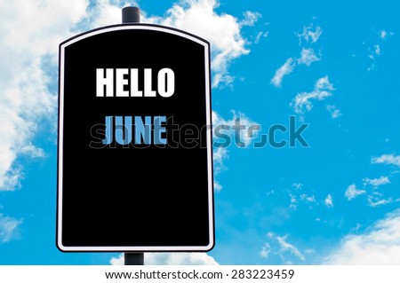 HELLO JUNE motivational quote written on road sign isolated over clear blue sky background with available copy space. Concept  image