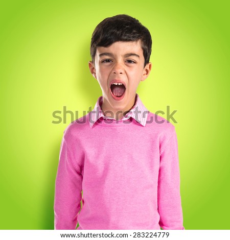 Child shouting over colorful background
