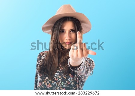 Woman making horn gesture over colorful background
