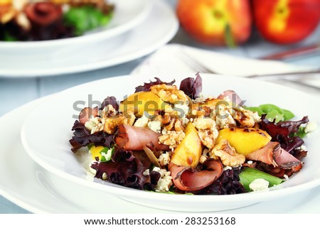 Peach, Gorgonzola And Pastrami Salad with a balsamic vinaigrette. Extreme shallow depth of field with selective on salad in foreground. 