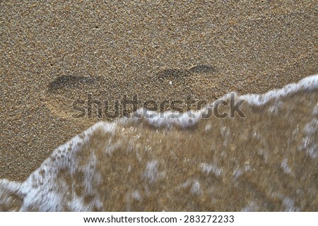Footprints in the sand by the sea 