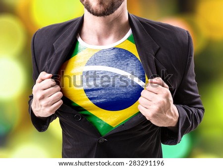 Businessman stretching suit with Brazil flag on bokeh background